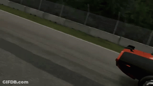 A Red And Black Dodge Car Is Driving Down A Race Track GIF