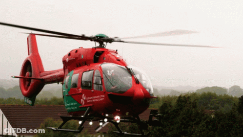 A Red And Green Helicopter With The Word Northern Ireland On The Side GIF