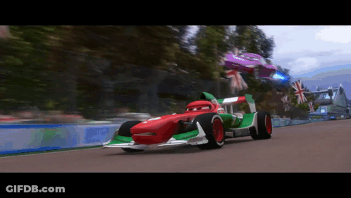 A Red And Green Race Car Is On A Track GIF