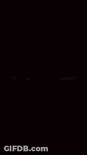 A Red And Purple Eye On A Black Background GIF