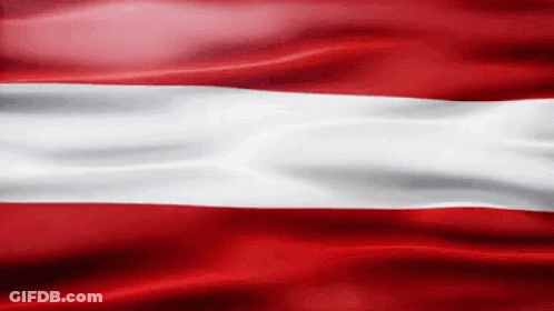 A Red And White Flag Is Waving In The Wind .. GIF