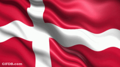 A Red And White Flag With A Cross On It Is Waving In The Wind GIF