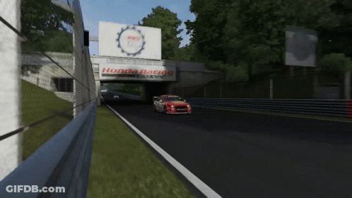 A Red And White Honda Racing Car Is Driving Down A Track GIF