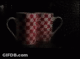A Red And White Mug Is Visible Through A Microwave Door GIF