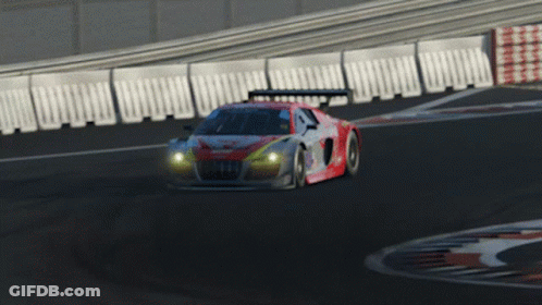 A Red And White Race Car Is Driving Down A Road GIF