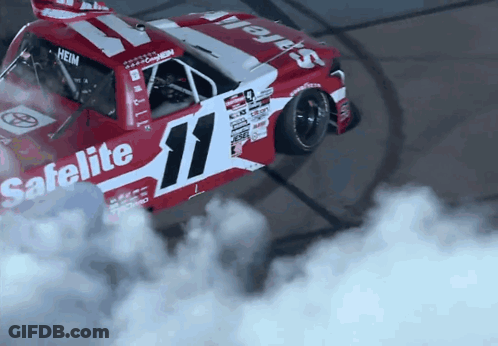 A Red And White Race Car With The Number 11 On The Side GIF