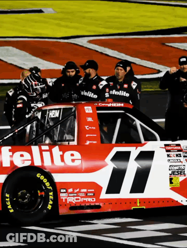 A Red And White Race Car With The Number 11 On The Side GIF