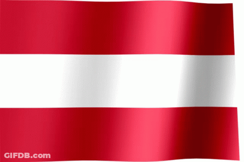 A Red And White Striped Flag Is Waving In The Wind GIF