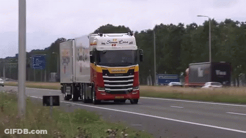 A Red And White Truck With The Word Scania On The Side GIF