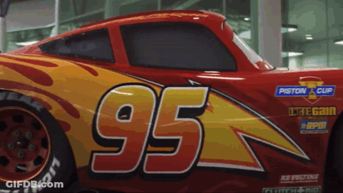 A Red And Yellow Car With The Number 95 On The Side GIF