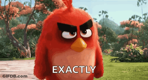 A Red Angry Bird From The Angry Birds Movie Is Standing In A Grassy Field . GIF