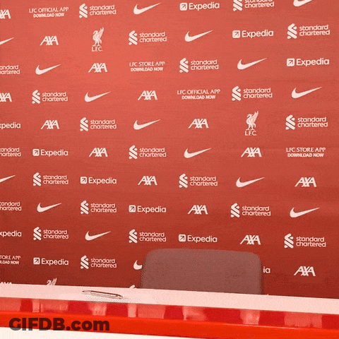 A Red Backdrop With Nike And Expedia Written On It GIF