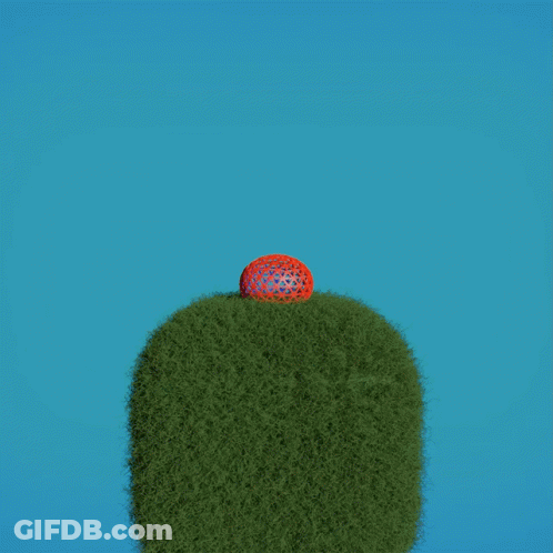 A Red Ball Is Flying In The Air Above A Grassy Hill GIF