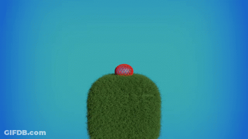 A Red Ball Is Flying Through The Air Over A Green Hill GIF