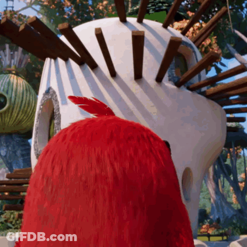 Red Bird Standing In Front Of White Building GIF