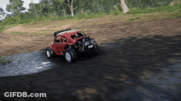 A Red Buggy Is Driving Through A Muddy Area GIF