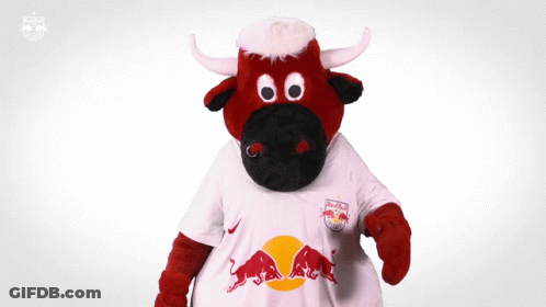 A Red Bull Mascot Is Wearing A White Shirt That Says Red Bull GIF