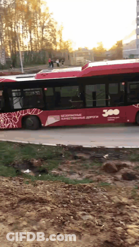 A Red Bus That Says 300 On The Side Of It GIF