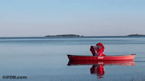 A Red Canoe With A Canadian Flag On Top Of It GIF