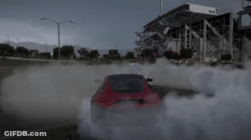 A Red Car Is Drifting In A Parking Lot With Smoke Coming Out Of The Tires GIF