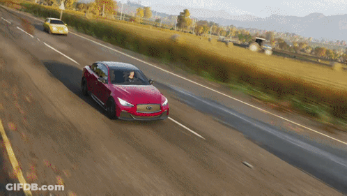 A Red Car Is Driving Down A Country Road GIF