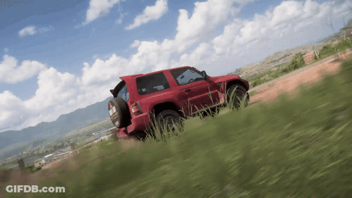 A Red Car Is Driving Down A Dirt Road GIF