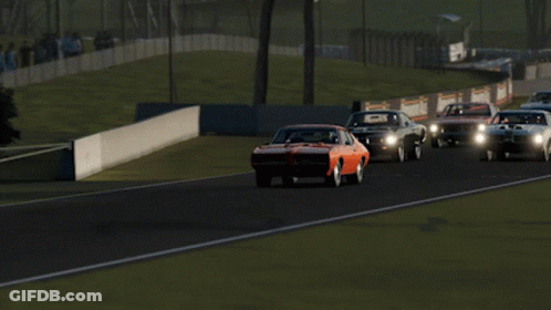 A Red Car Is Driving Down A Race Track GIF