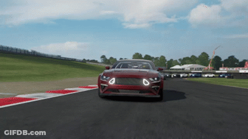 A Red Car Is Driving Down A Race Track In A Video Game GIF