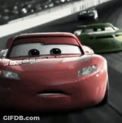 A Red Car Is Driving Down A Race Track With A Green Car Behind It . GIF