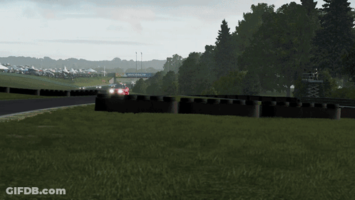 A Red Car Is Driving Down A Race Track With A Sign That Says Michelin On The Side GIF