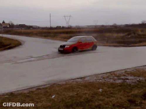 A Red Car Is Driving Down A Road In The Rain GIF