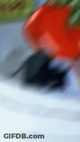 A Red Car Is Driving Down A Road With A Blue Sky In The Background GIF