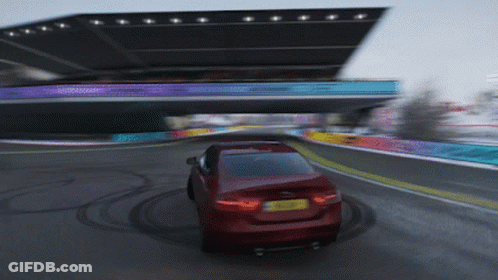 A Red Car Is Driving Down A Road With A Yellow License Plate That Says ' A ' GIF