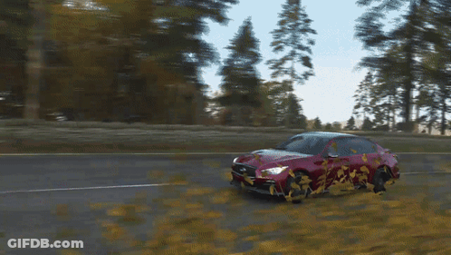 A Red Car Is Driving Down A Road With Trees Behind It GIF