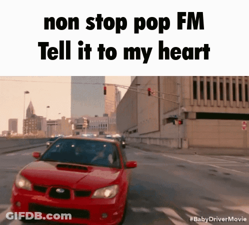A Red Car Is Driving Down A Street With The Words " Non Stop Pop Fm Tell It To My Heart " GIF