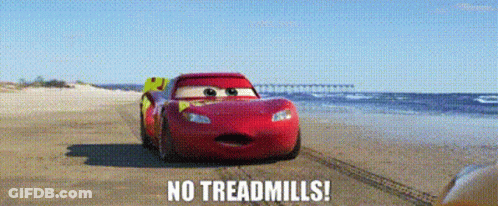 A Red Car Is Driving On A Beach With The Words `` No Treadmills '' Written On It . GIF