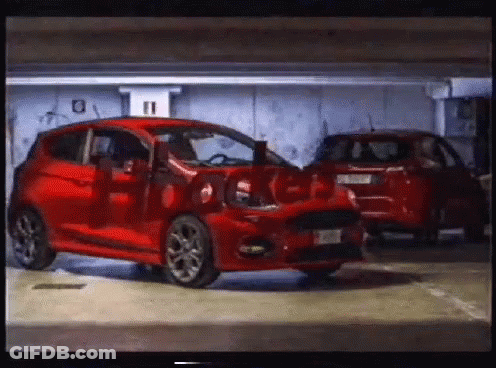 A Red Car Is Parked In A Garage With The Number 11 On The Wall Behind It GIF