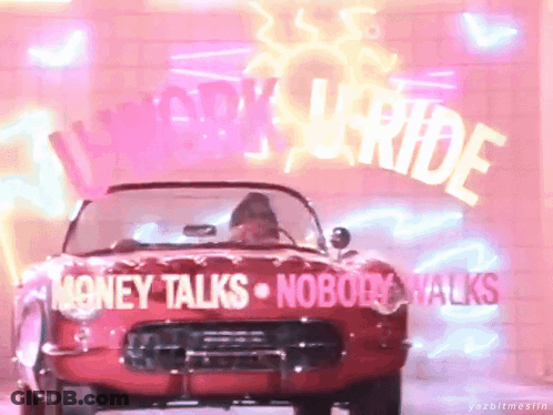 A Red Car Is Parked In Front Of A Neon Sign That Says " Money Talks Nobody Walks " GIF