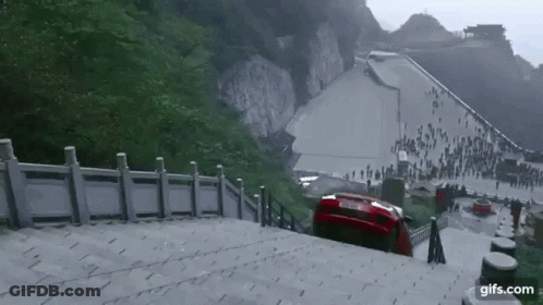 A Red Car Is Stuck On A Set Of Stairs With The Website Gifs.com In The Lower Right Corner GIF