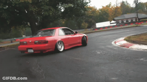 A Red Car On A Track With A License Plate That Says ' Nc ' GIF