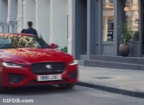 A Red Car With A License Plate That Says Rebellxee GIF