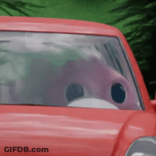 A Red Car With A Pink Flamingo In The Driver 'S Seat .. GIF