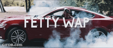 A Red Car With Smoke Coming Out Of It And The Words Fetty Wap GIF