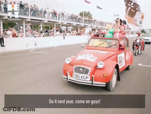 A Red Car With The License Plate E961 Acp Is Driving Down The Road GIF