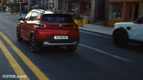 A Red Car With The License Plate Vm-D80-Vx GIF