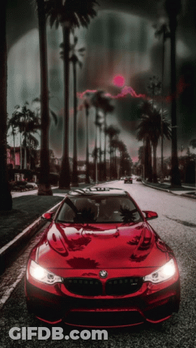 A Red Car With The Word Bmw On The Front GIF