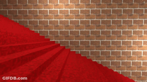 A Red Carpeted Staircase Leading Up To A Brick Wall GIF