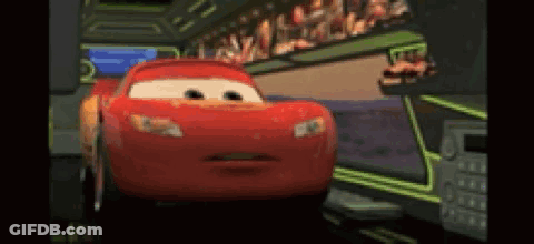 A Red Cartoon Car From The Movie Cars Is Driving Down A Road . GIF