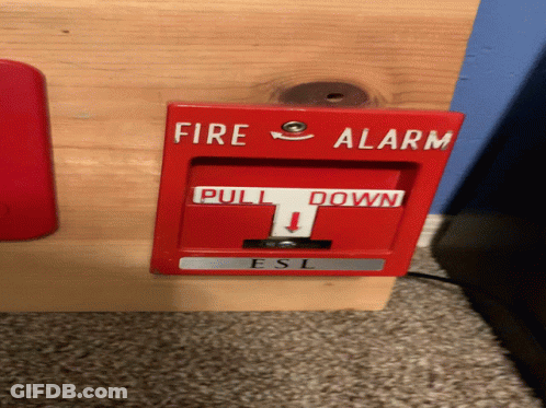 A Red Fire Alarm That Says Pull Down GIF
