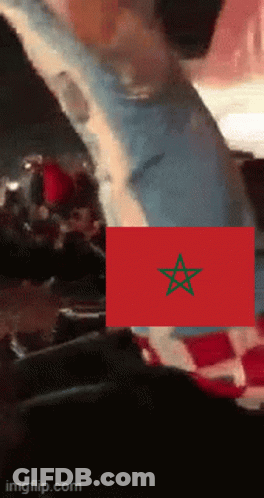 A Red Flag With A Green Star On It Is Being Displayed On A Screen GIF
